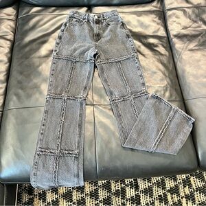 High rise black flared jeans with frayed seams on the front and back